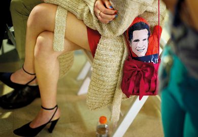 A student with a Mitt Romney mitten in her purse attends a debate watch party, 2012