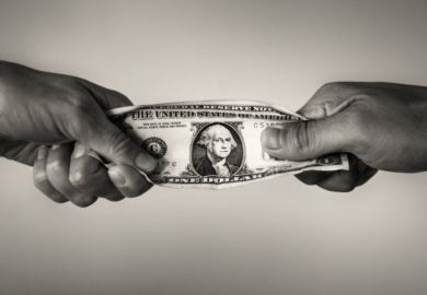 People pull on a dollar bill, illustrating competition for resources People pull on a dollar bill, illustrating competition for resources