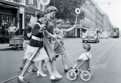 Mother and children crossing road