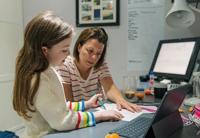 A mother helps child with homework