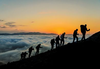 people climbing mountain with mist below people climbing mountain with mist below