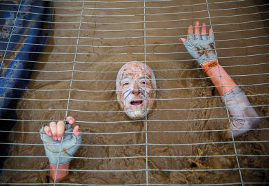 Muddy obstacle in Tough Mudder race Muddy obstacle in Tough Mudder race