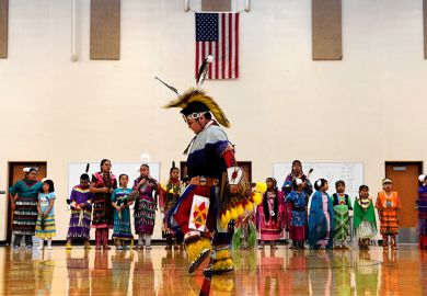 A student performs a traditional style dance in full regalia at the 21st Century Community Learning Center, USA. Students that are part of the after school learning program learn the Arapaho language, culture, history and traditions of the Arapaho tribe.