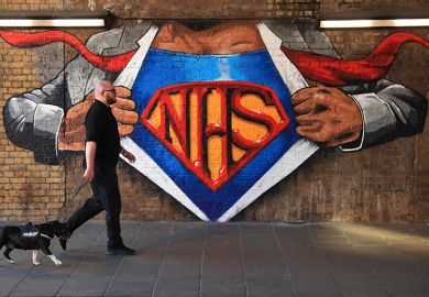 A man and a dog walk past an NHS mural showing superman, illustrating that a new applied research centre focused on NHS transformation could be created. A man and a dog walk past an NHS mural showing superman, illustrating that a new applied research centre focused on NHS transformation could be created.