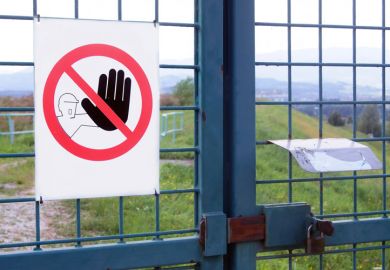 'No admission' sign on gated fence