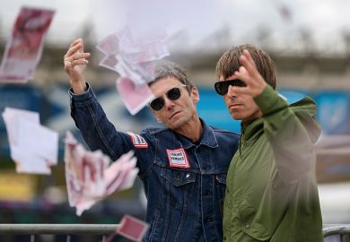 Oasis lookalikes of Liam and Noel Gallagher throwing fake money pose for photographs. To illustrate universities using ‘dynamic pricing’ with overseas students offered thousands off fees.