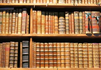 Old books arranged on library bookshelves