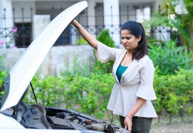 An Indian woman looks at the engine of her car An Indian woman looks at the engine of her car, symbolising open science
