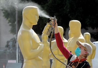 Woman spray paints giant Oscar statues