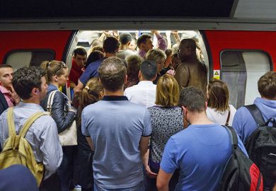 Commuters queuing for tube trains at Green Park Tube Station in evening rush hour in London, England. To illustrate that universities are churning out PhD graduates that have little prospect of securing an academic job.
