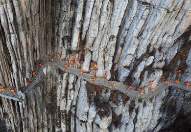 Martial artists practice kung fu on the cliffs at Mount Song, Dengfeng, Henan Province of China