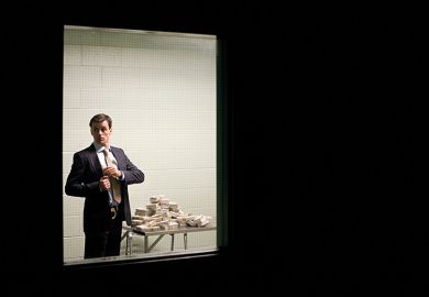 Man putting cash in his pocket behind closed door Man putting cash in his pocket behind closed door