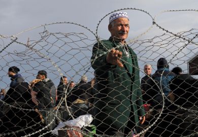 Palestinian man standing behind barbed fence, Gaza Strip, 2014 Palestinian man standing behind barbed fence, Gaza Strip, 2014