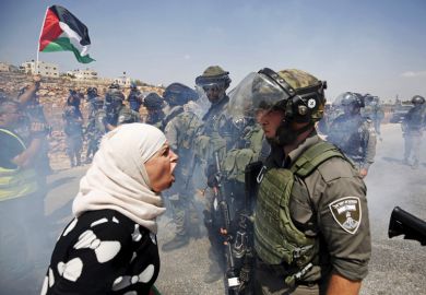 Palestinian woman argues with Israeli border policeman, West Bank