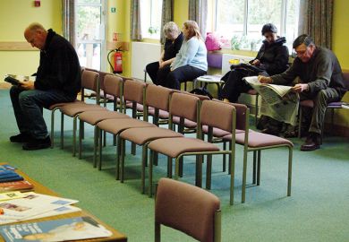 Patients sitting in doctors surgery waiting room