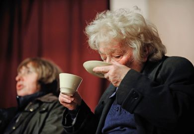 Woman drinking tea from saucer