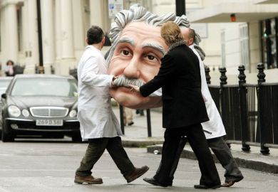 People carrying model of Albert Einstein's head, Science Museum, London, England People carrying model of Albert Einstein's head, Science Museum, London, England