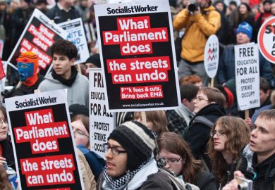 People holding signs at a protest People holding signs at a protest