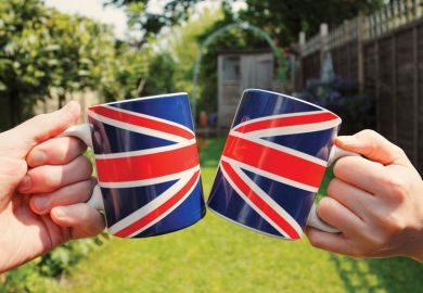People holding Union Jack flag tea cups