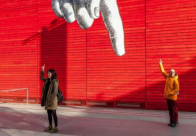 Tourists holding up their fingers, under a giant cartoon finger outside the National Gallery, London, England. To illustrate a government proposal to take a cut of overseas income to pay for HE dismissed as ‘finger in the air" policymaking