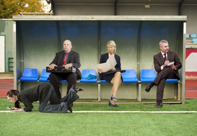 People in suits sitting on a soccer substitute bench. To illustrate that Skills England has no clear role in forming or implementing policy.