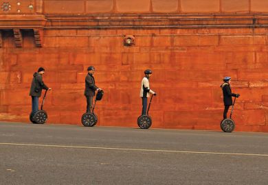 People riding Segways past Indian Home Ministry, New Delhi