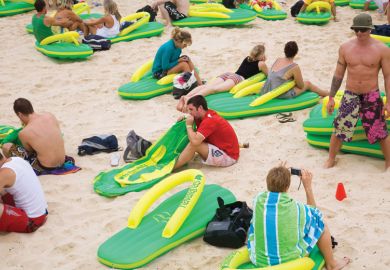 People sitting on the beach on giant lilos People sitting on the beach on giant lilos