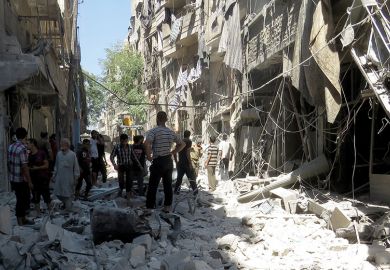 People standing among rubble of destroyed buildings, Aleppo, Syria People standing among rubble of destroyed buildings, Aleppo, Syria