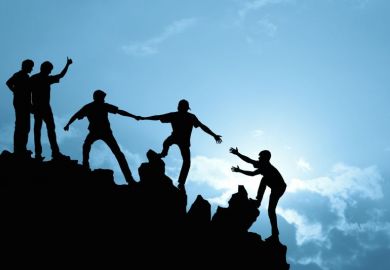 People helping each other up a hill