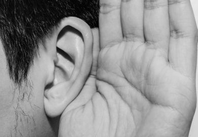 Person cupping hand to ear