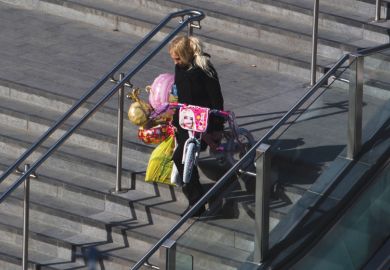 Person laden with children's presents, Westfield shopping centre