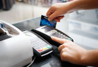 Person swiping credit card instore