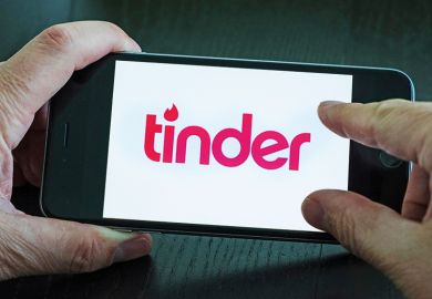 Person using Tinder on Apple iPhone smartphone