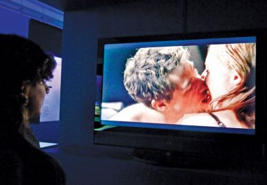 Person watching sex scene on television screen, Museum of Sex, New York City