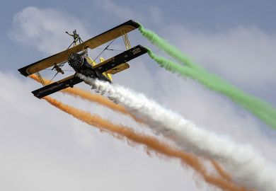 Biplane trailing coloured smoke