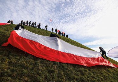 People carry huge Polish flag while attending National Liberation Rally to illustrate Fears for future of top research agency 