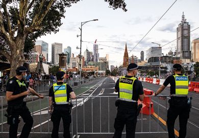 Members of Victoria Police patrol St. Kilda Road, Melbourne
