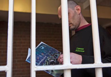 An inmate reads a book in jail to illustrate Books behind bars: the shifting fortunes of prison education