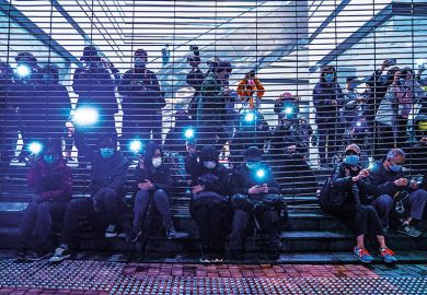 Pro-democracy demonstrators raise flashlights outside West Kowloon Magistrates’ Courts in Hong Kong on March 4, 2021. Pro-democracy demonstrators raise flashlights outside West Kowloon Magistrates’ Courts during a hearing for 47 opposition activists charged with violating the city’s national security law in Hong Kong, China, on March 4, 2021.