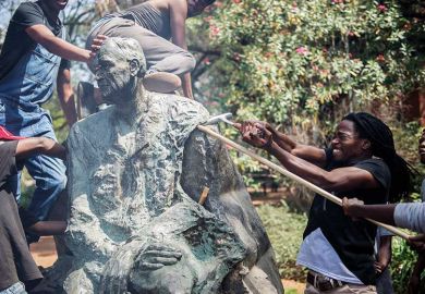 Protesters attacking statue