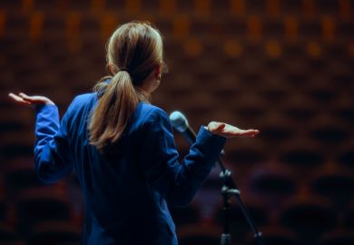 A public speaker shrugs