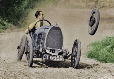 Racecar losing wheel as it turns corner