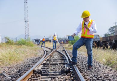 Railway engineers inspect a junction, symbolising university bureaucracy