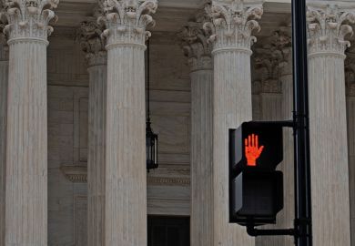 Red hand stop sign in from of classical columns to illustrate that serious abuses should stop being investigated only by universities.
