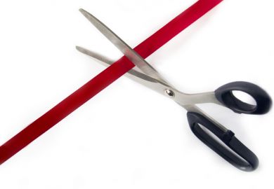 scissors cutting red tape