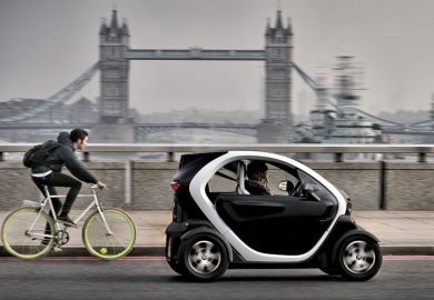 Renault Twizy electric car and cyclist on London Bridge Renault Twizy electric car and cyclist on London Bridge