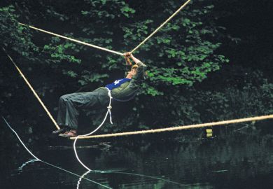 Man crosses river via rope Man crosses river via rope