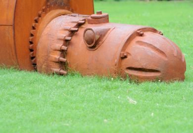 A rusty iron robot sculpture at the University of Alabama, sybolising university obsolescence A rusty iron robot sculpture at the University of Alabama, sybolising university obsolescence