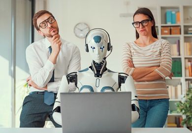 Two people scrutinise a robot