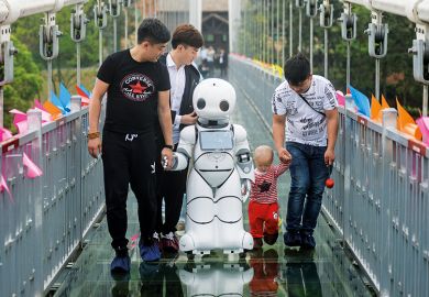 People with robot on bridge